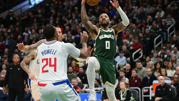 Milwaukee Bucks guard Damian Lillard (0) takes a shot against Los Angeles Clippers guard Norman Powell (24) 